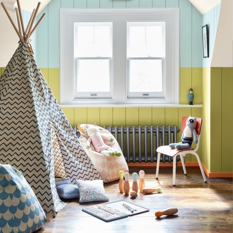 Bold green and orange paint colours in a children's playroom