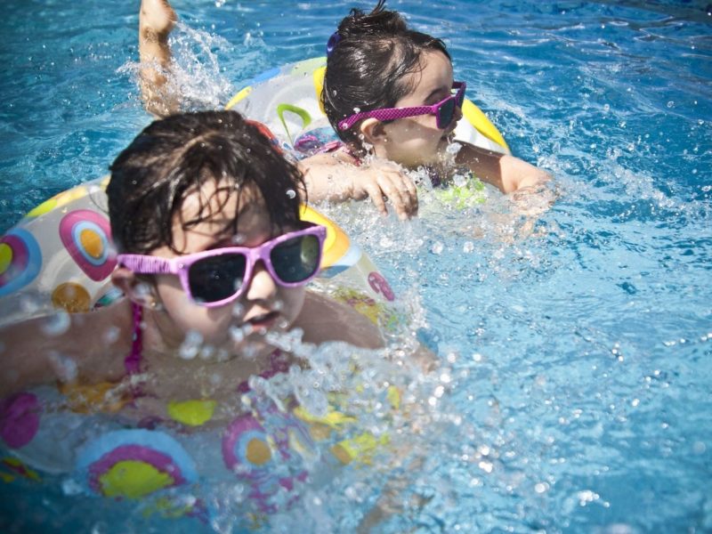 Kids in the pool wearing sunglasses