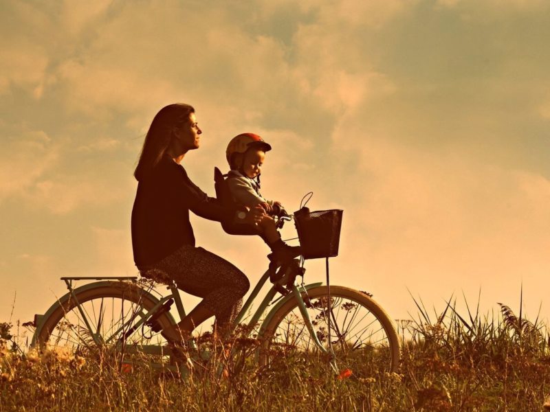 Mum riding a bike with child