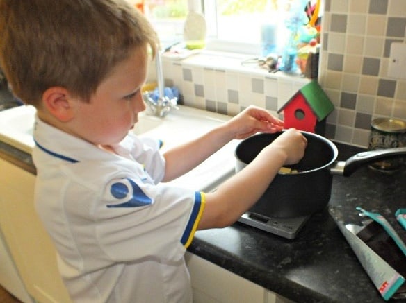 Breaking the chocolate chunks into a saucepan