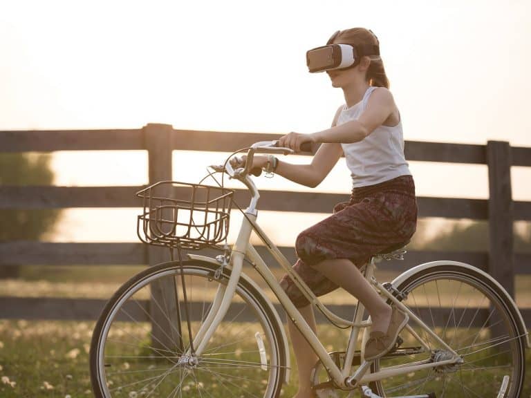 Girl riding bike whilst wearing a VR headset