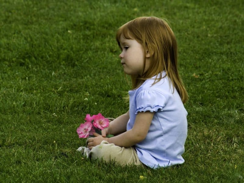 Young girl sitting on the lawn