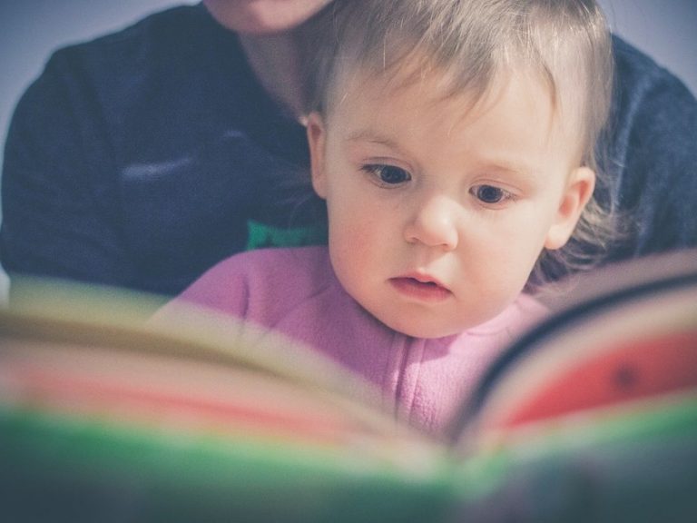 Child reading with her mum