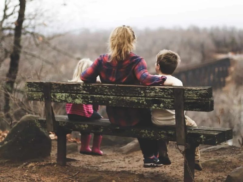 Mum sat on bench with 2 kids