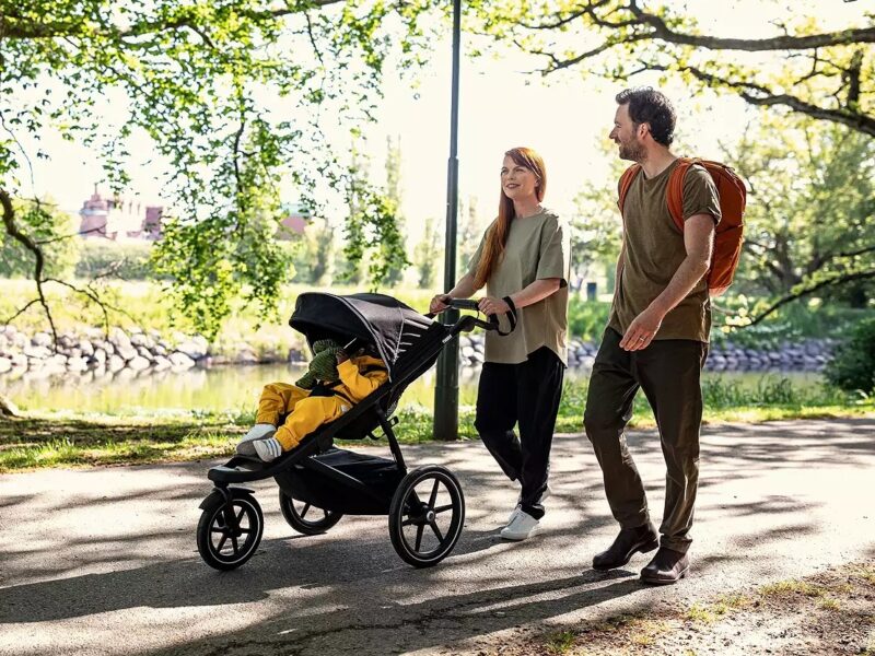 Couple out walking with baby in a stroller