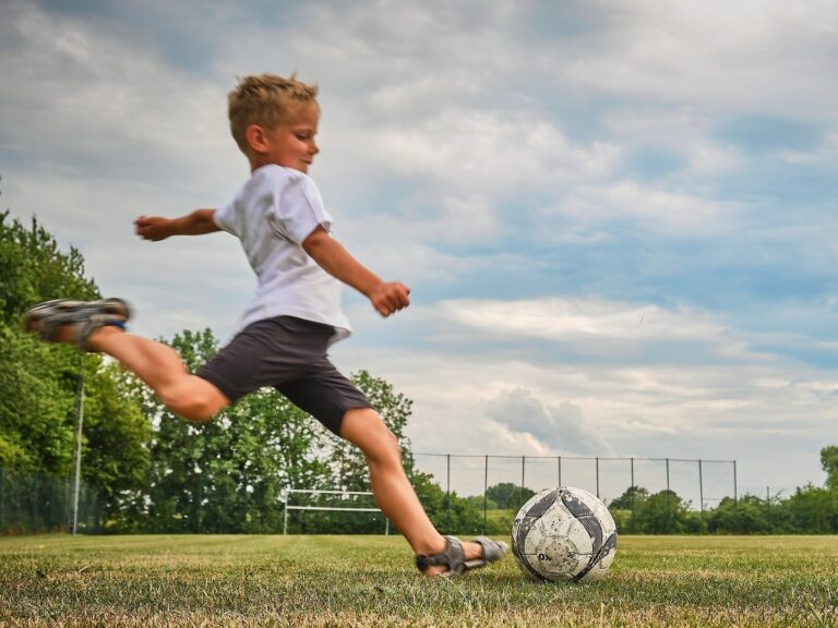 Boy kicking football