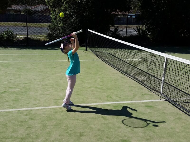 Child playing tennis