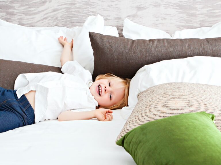 Boy laying on a large bed