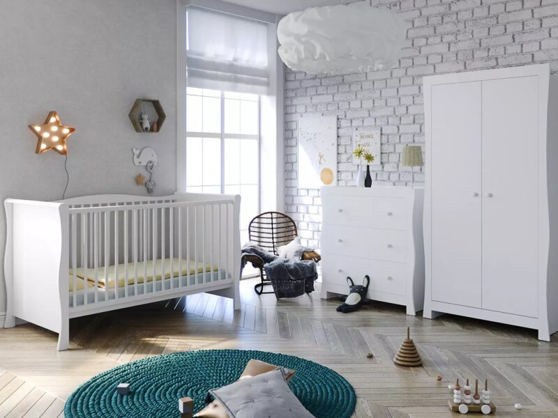 White-painted sleigh-style nursery furniture