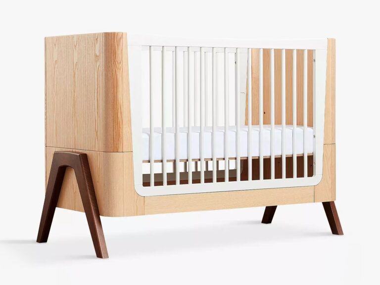 Oak cot bed with white rails and walnut legs