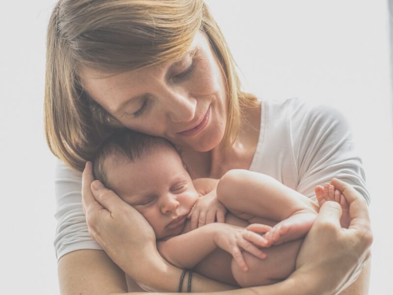 Mother holding sleeping baby