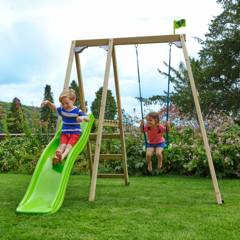 Children playing on a wooden swing and slide set