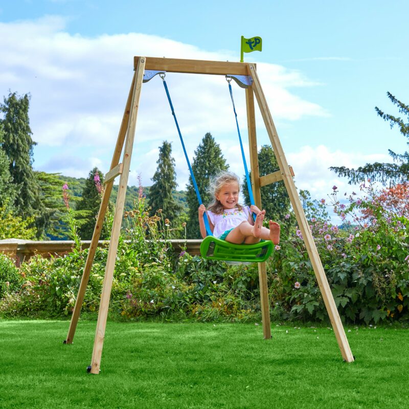 Child playing on a single wooden swing