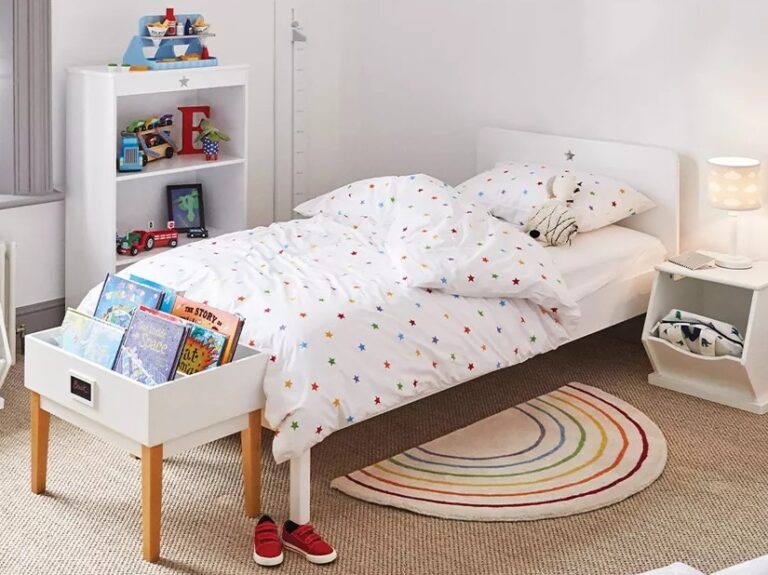 White-painted bed frame and matching bookcase with star cut-outs