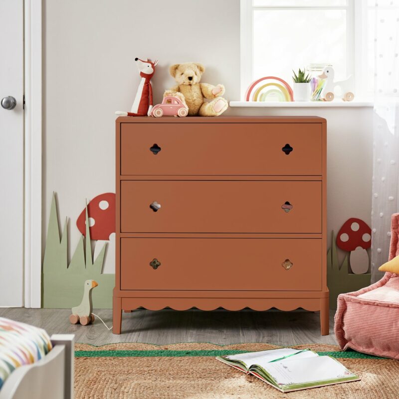 Rust coloured 3-drawer chest with cut-out handles and scallop detailing