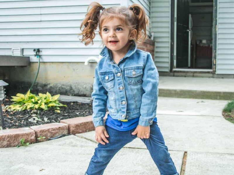 Young girl wearing denim jacket and jeans